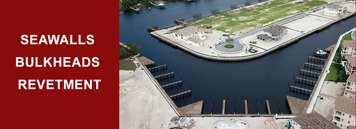 aerial view of island or peninsula surrounded by a seawall. text " Seawalls Bulkheads Revetment"